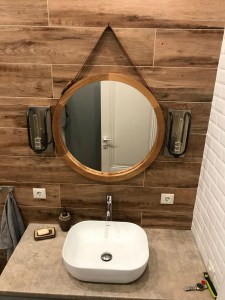 Круглое зеркало в раме из массива на кожаном ремне в ванной (рама дуб)
